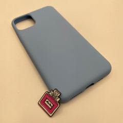 Pinkgul.no decorative metal perfume bottle sticker attached to a matte blue smartphone case on a beige background