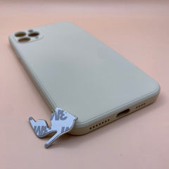 Pinkgul.no decorative metal high heel shoe sticker with adhesive backing placed next to a beige smartphone case