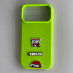 Pinkgul.no neon green phone case with Nissan GT-R, Jonathan name, and car metal stickers attached.