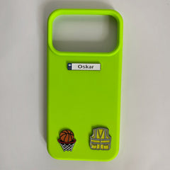 Pinkgul.no neon green phone case decorated with an Oskar metal name sticker, basketball, and safety vest charms.