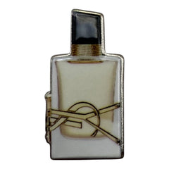 Pinkgul.no decorative metal sticker shaped like a perfume bottle with a gold logo design on a white background