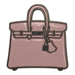 Pinkgul.no decorative metal sticker shaped like a small pink handbag with a raised design for mobile devices.