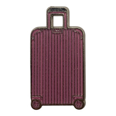 Pinkgul.no decorative metal sticker shaped like a pink suitcase with a raised ribbed design and silver trim.