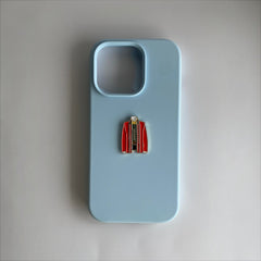 Pinkgul.no decorative metal sticker shaped like a red jacket attached to a light blue smartphone case