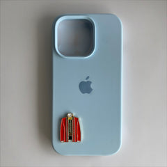 Pinkgul.no decorative metal sticker shaped like a red jacket attached to a light blue smartphone case