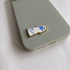 Pinkgul.no Rød Bunad decorative metal sticker with adhesive backing applied to a light green phone case