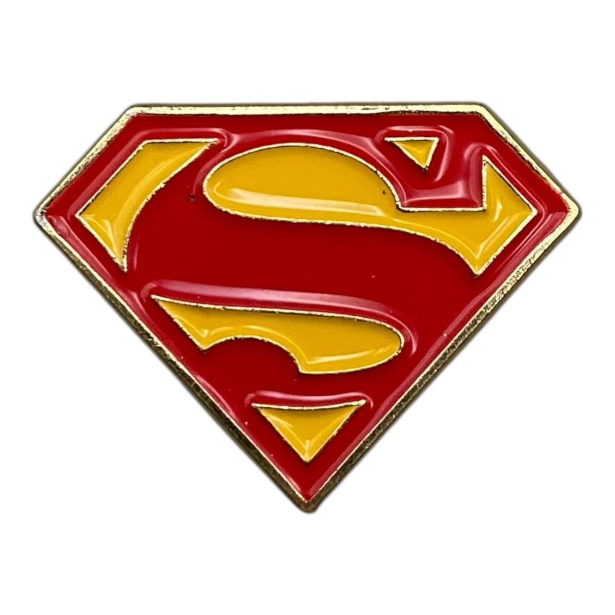 Pinkgul.no decorative metal Superman logo sticker with a raised red and yellow enamel design on a smooth surface