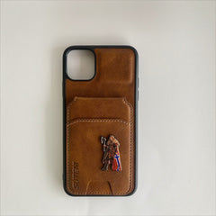 Pinkgul.no Vindra decorative metal sticker featuring a Viking warrior design attached to a brown leather phone case